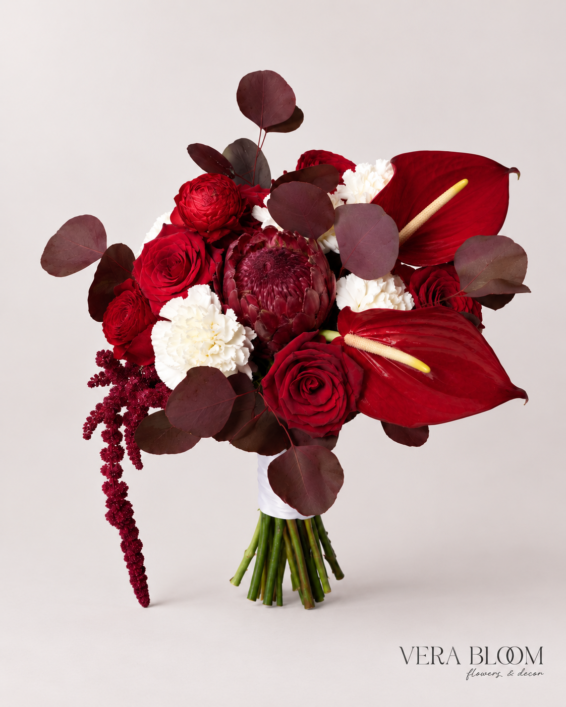Noir Rouge bridal bouquet with deep red flowers, dark foliage and trailing accents.