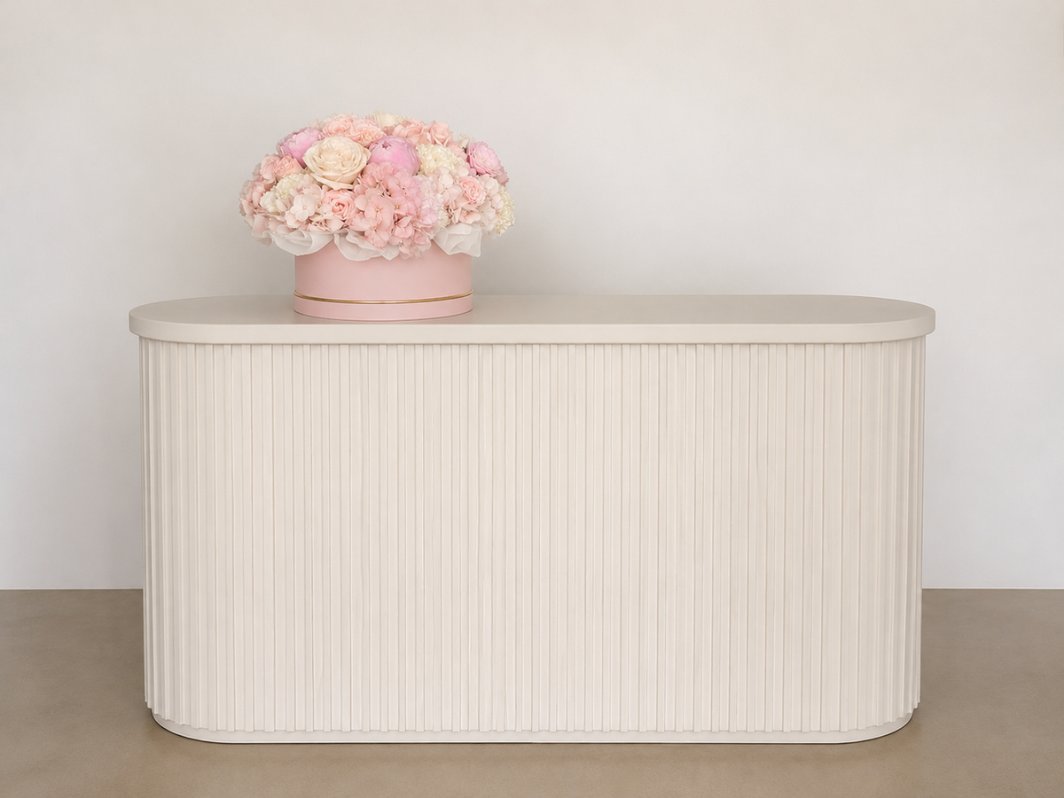 Original interior photograph of Rosé Garden Box with seasonal peonies displayed on a light fluted console.