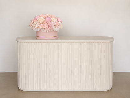 Original interior photograph of Rosé Garden Box with seasonal peonies displayed on a light fluted console.